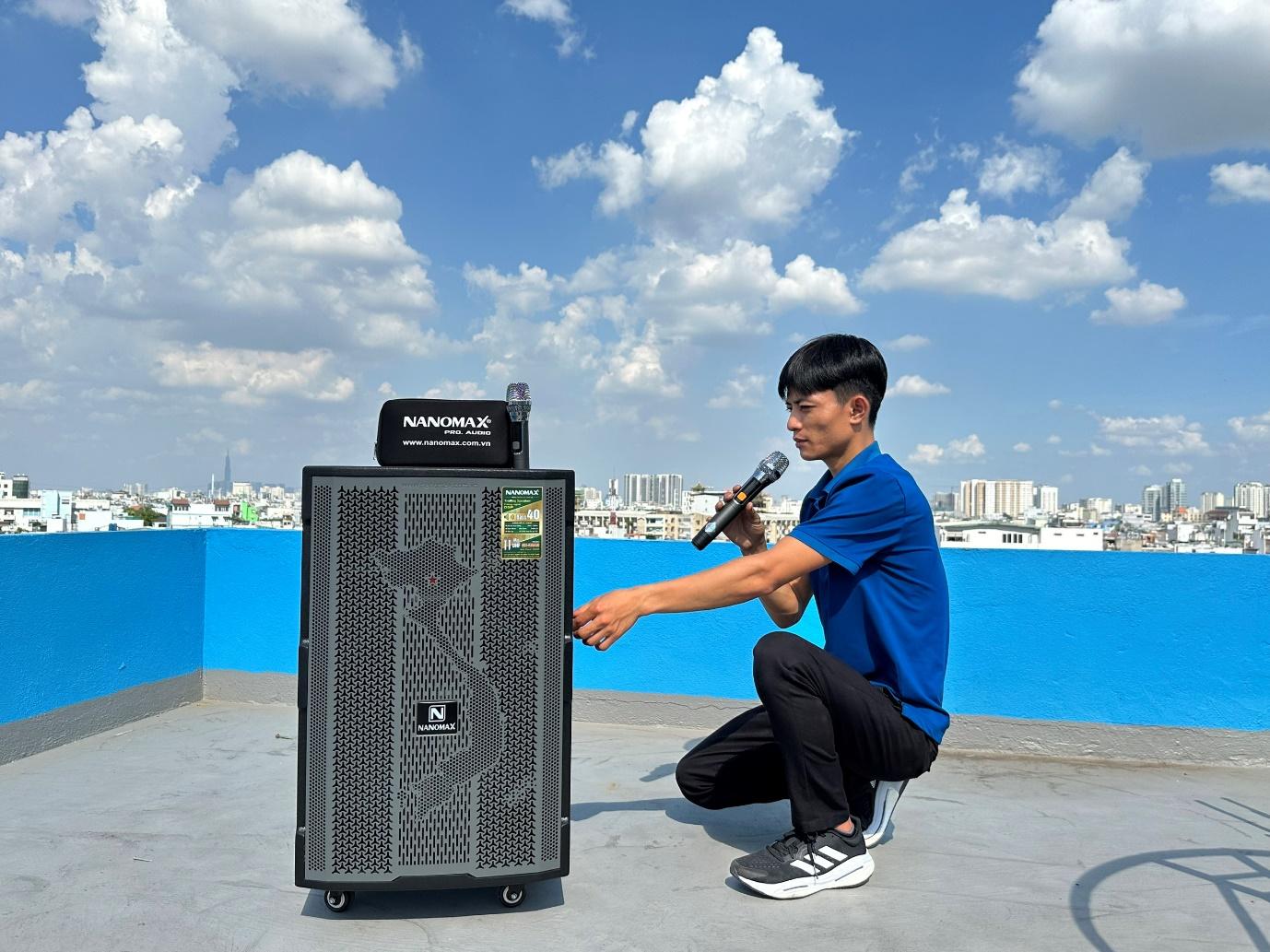 A person kneeling on a roof with a microphoneDescription automatically generated
